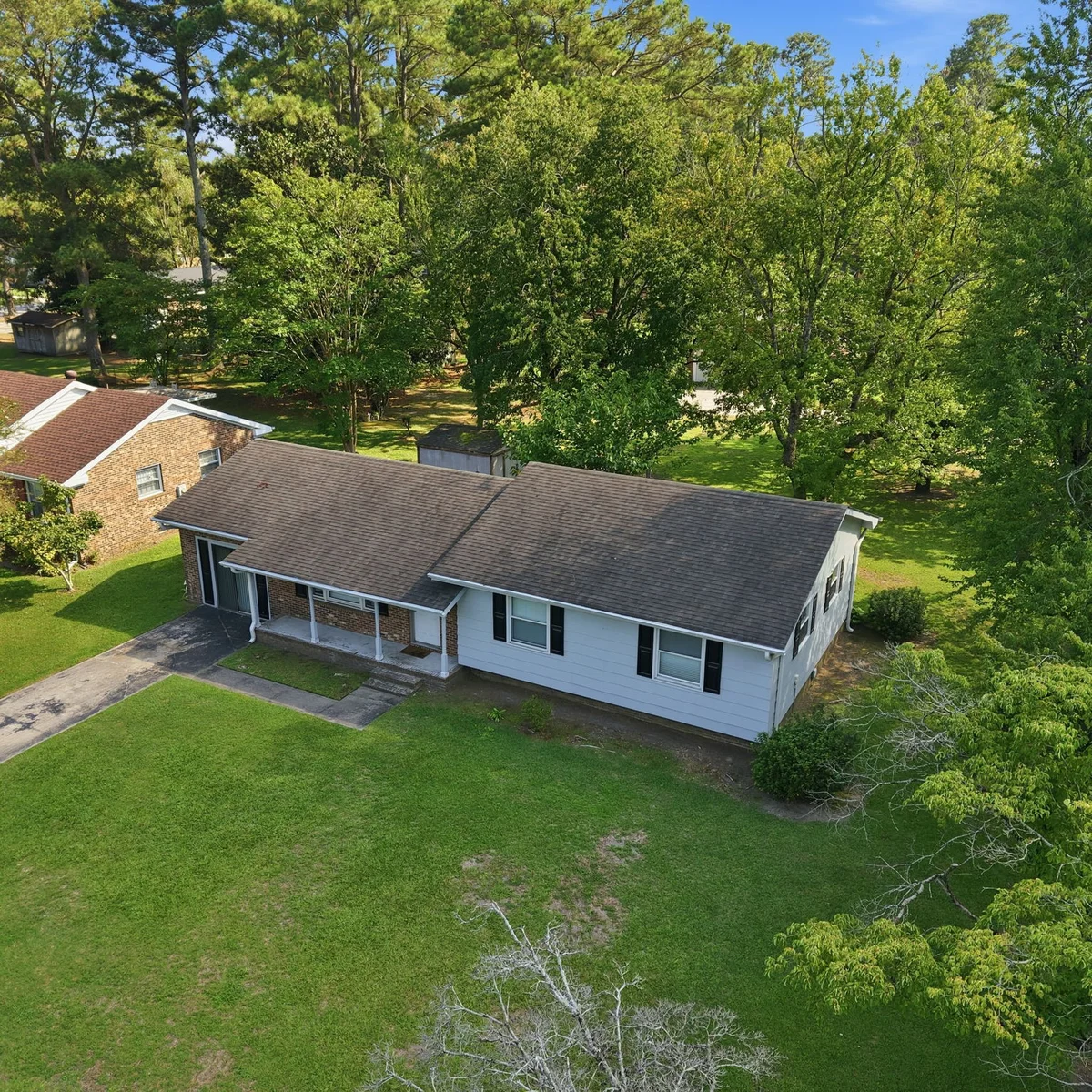 100 Pearl Drive in Greenville, NC from the street — a plain 1967 ranch with no hint of the murals inside