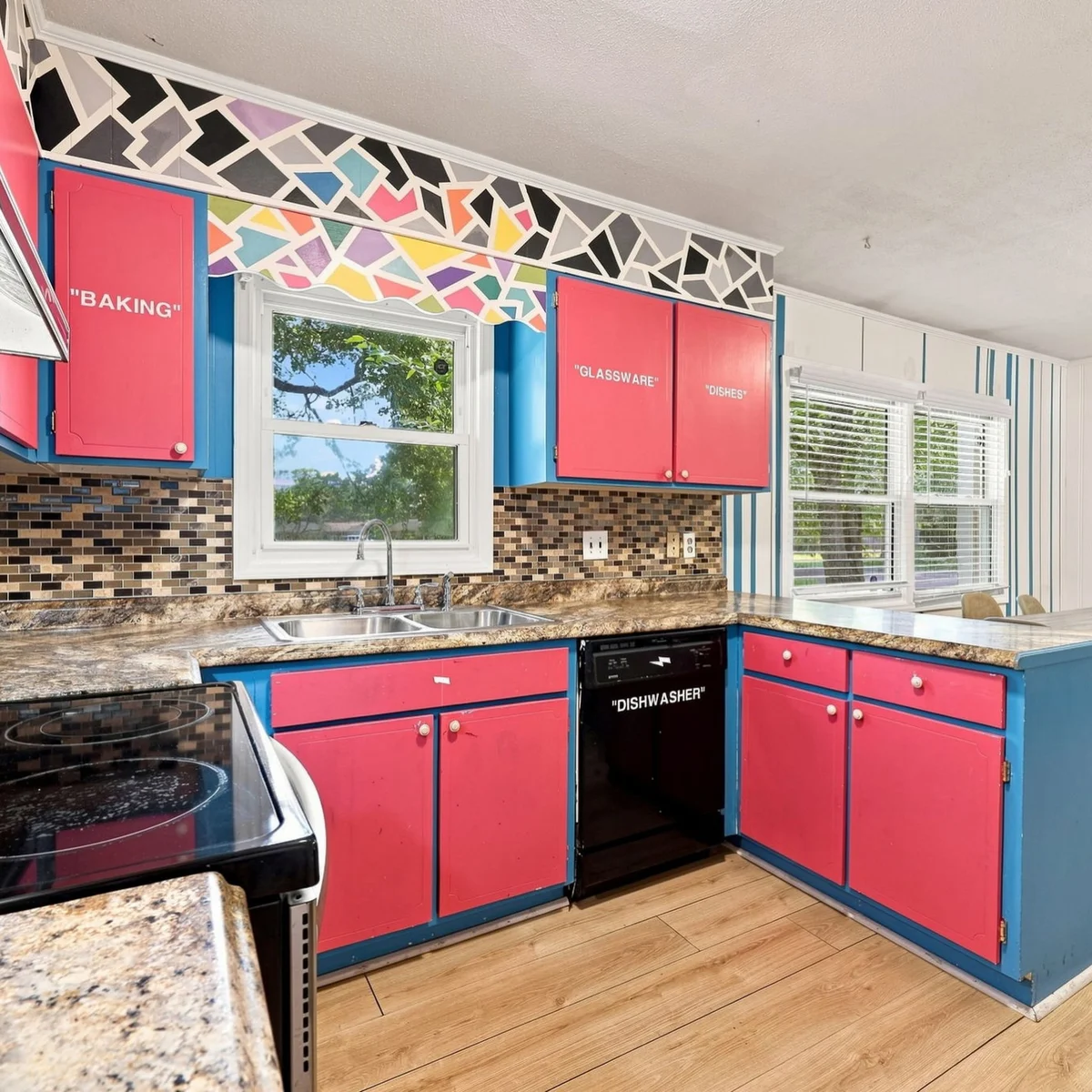 The MrBeast house kitchen at 100 Pearl Drive, with cabinets labeled BAKING, GLASSWARE, DISHES and the dishwasher labeled DISHWASHER